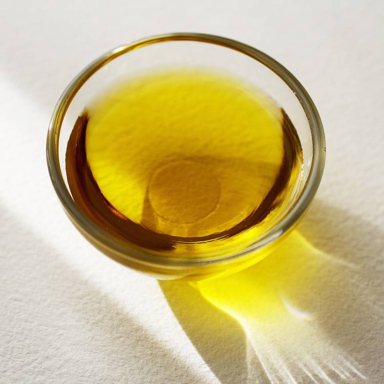 a small glass bowl filled with a yellow liquid